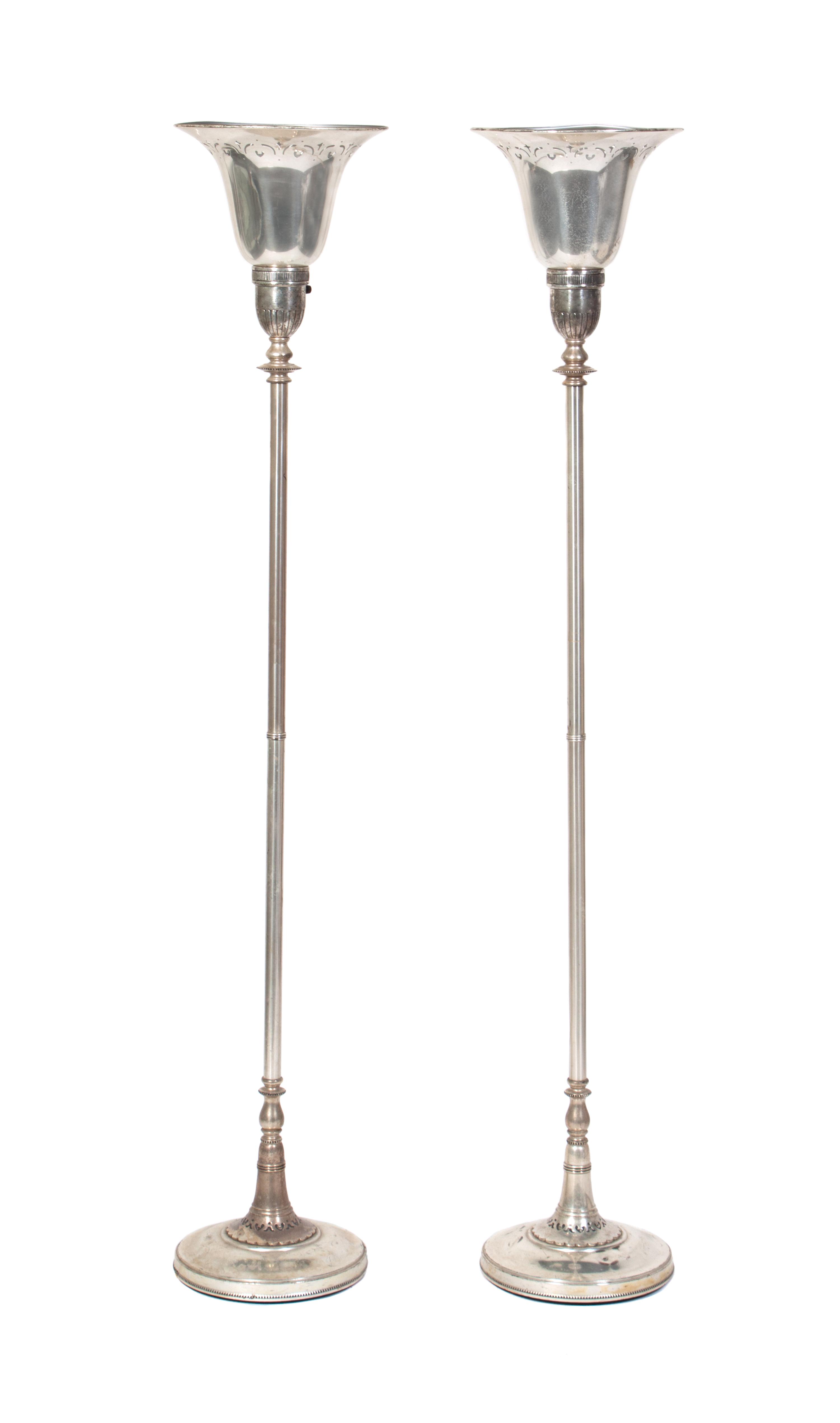 A Pair of Silver Torcheres Height 67 inches.