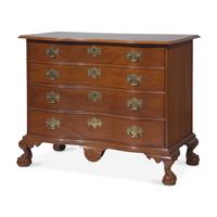 A Chippendale Figured and Shell-Carved Mahogany Reverse-Serpentine Chest of Drawers
