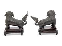 A Pair of Chinese Bronze Buddhistic Lions with Wood Stands
