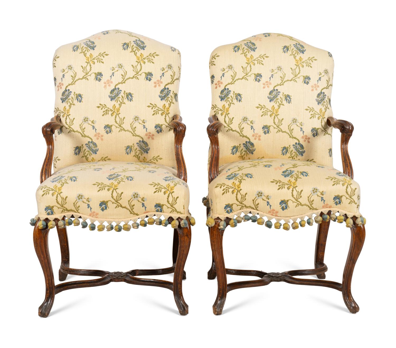 A Pair of Régence Walnut Open Armchairs