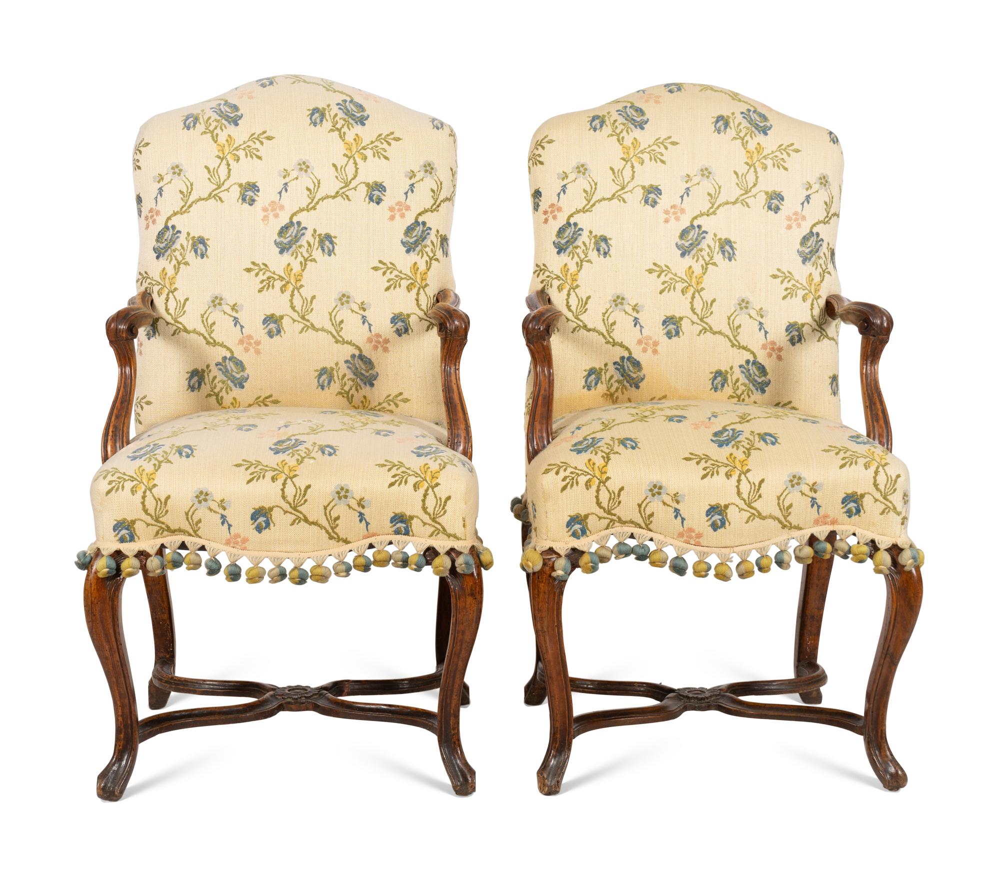 A Pair of Régence Walnut Open Armchairs