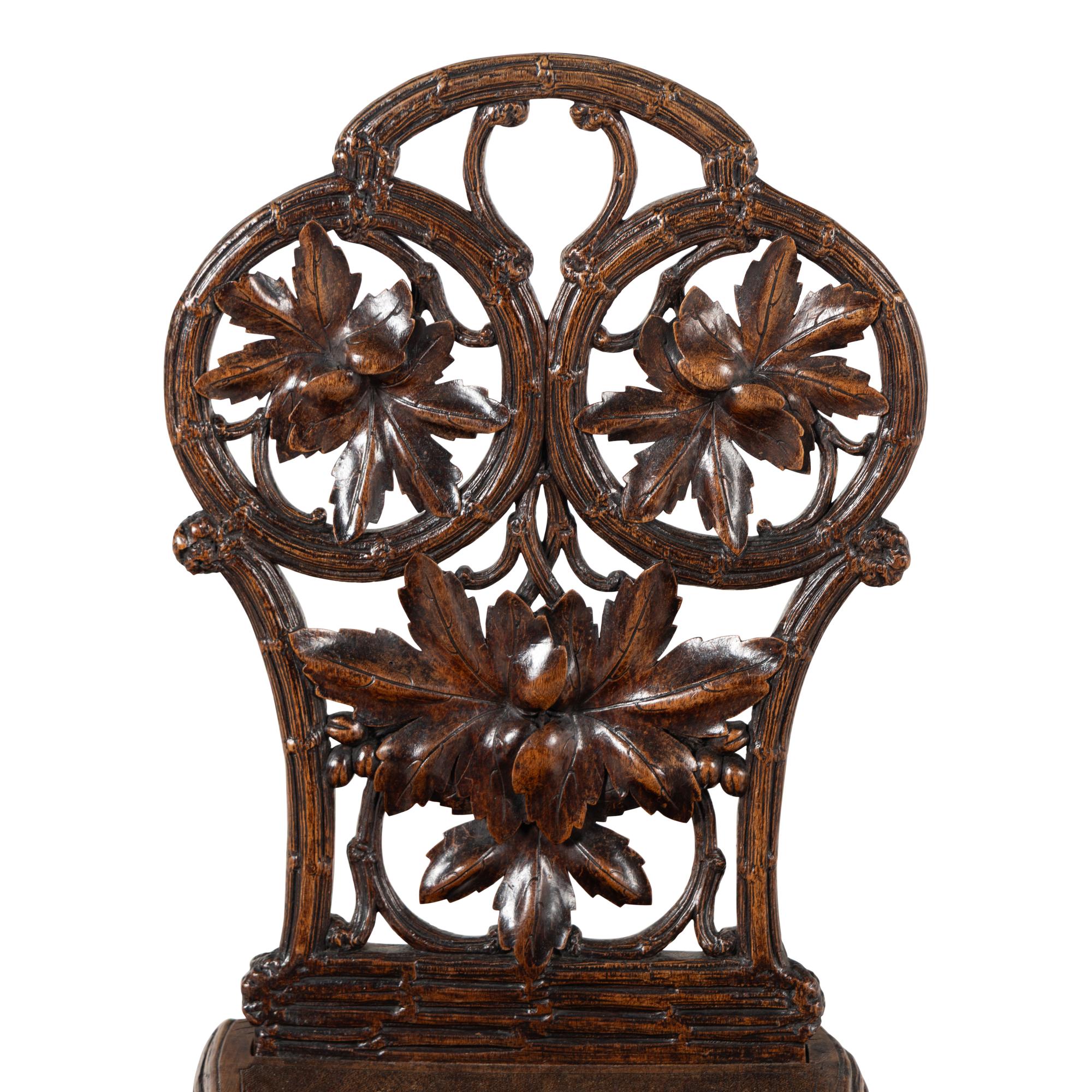 A Pair of Black Forest Oak Leaf Carved Side Chairs