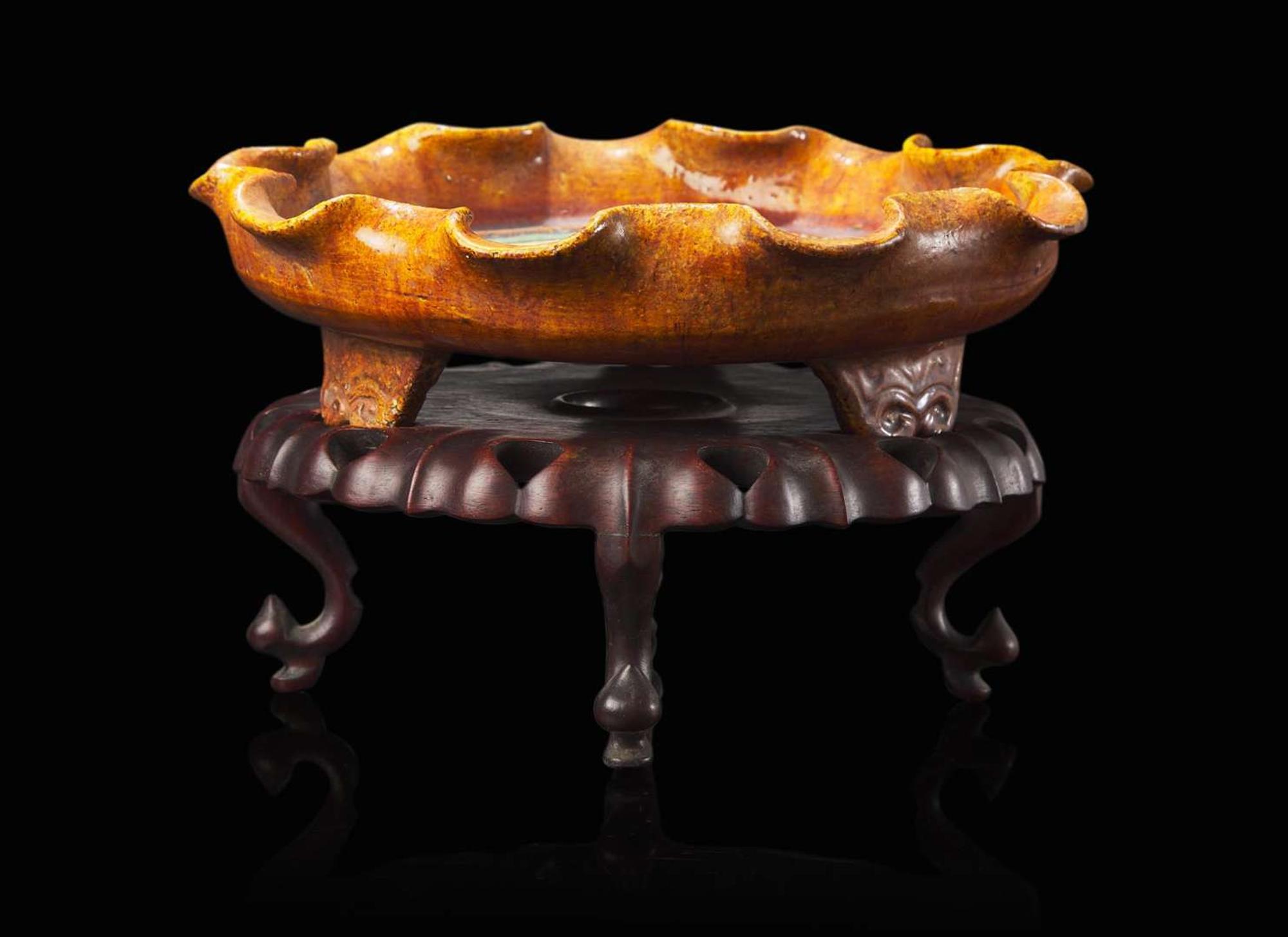 A Chinese sancai-glazed tripod dish with wood stand, possibly Ming dynasty 三彩三足盤帶底座 可能為明