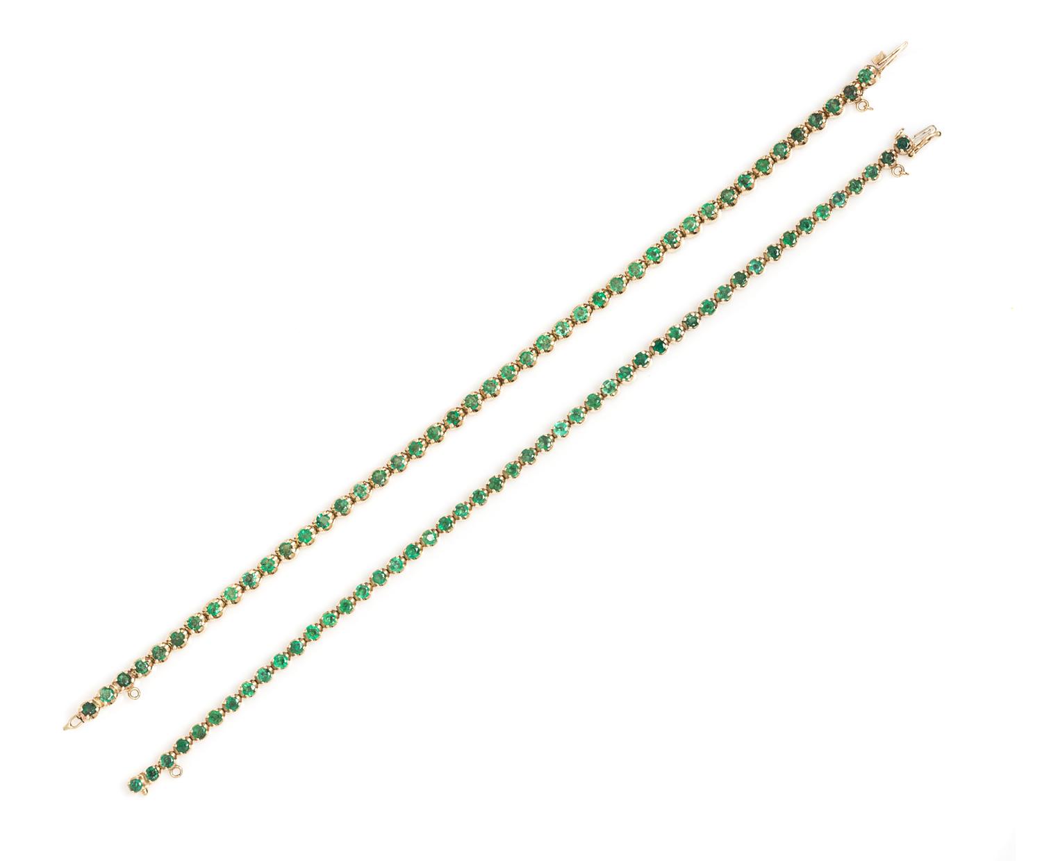 A Pair of 14 Karat Yellow Gold and Emerald Line Bracelets, 17.40 dwts.