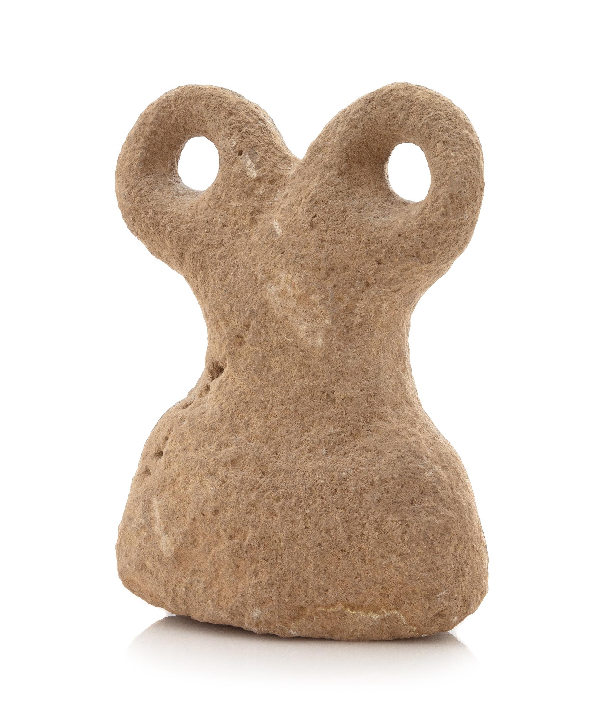 A Syrian Basalt Spectacle Idol Height 5 5/8 x width 4 1/8 inches. — CIRCA 4TH MILLENNIUM B.C.E.