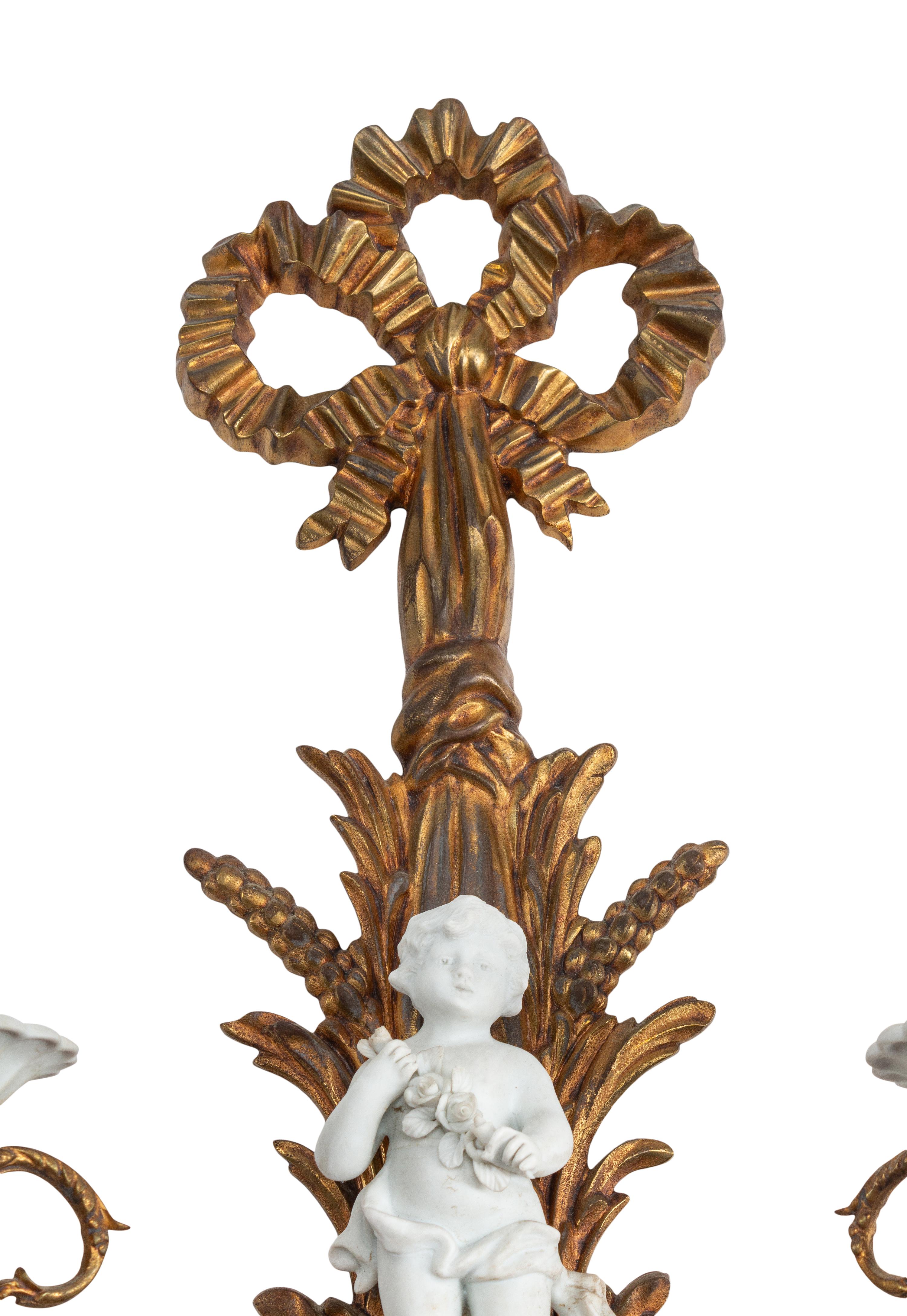 A Pair of Continental Gilt Bronze and Bisque Porcelain Two-Light Sconces