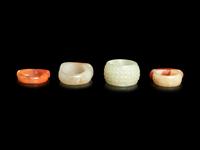 Four Chinese Jade and Hardstone Archer's Rings