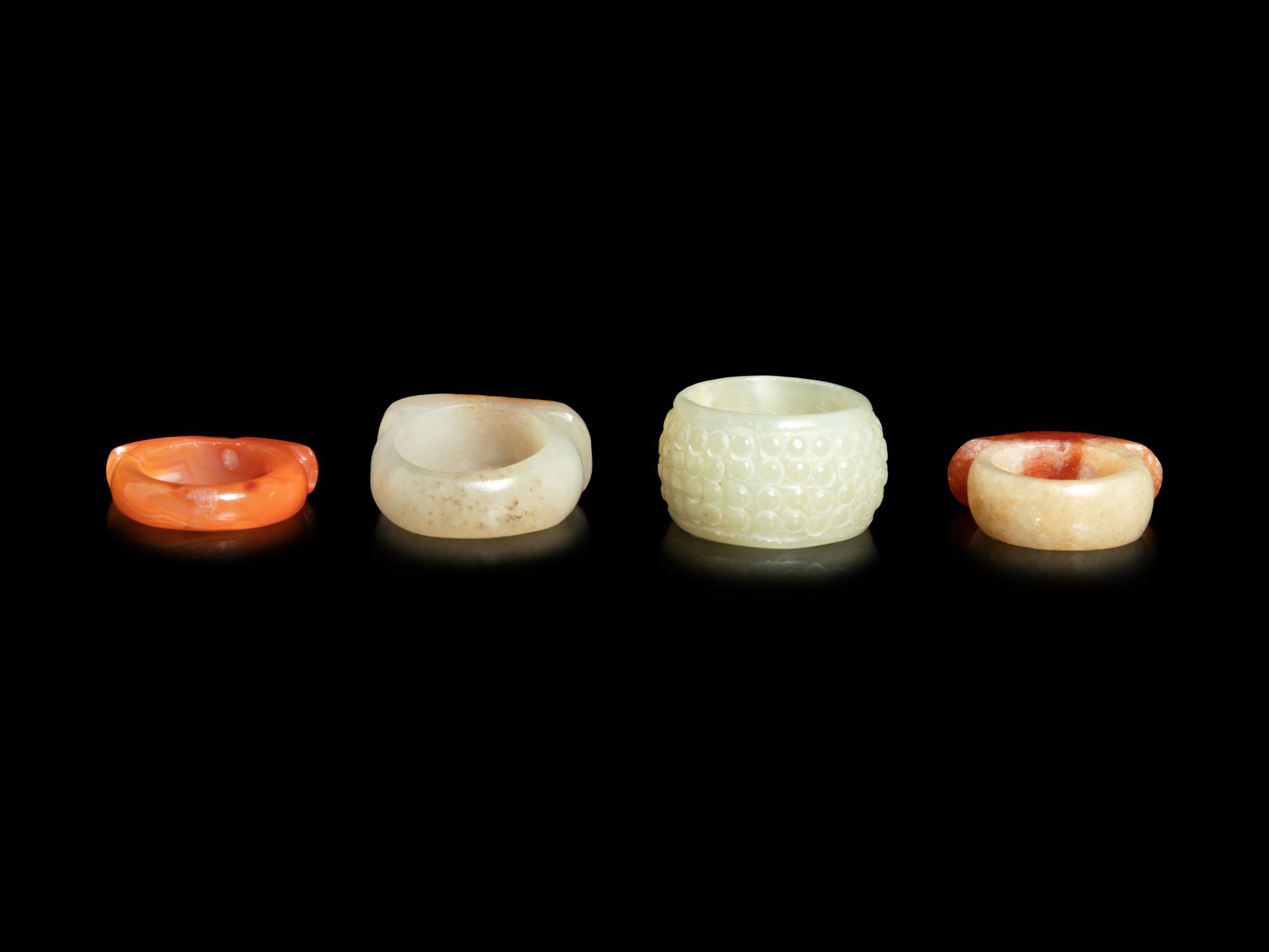 Four Chinese Jade and Hardstone Archer's Rings