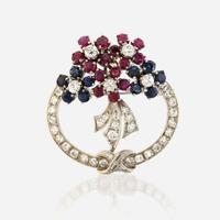 A diamond, ruby, sapphire, and white gold pendant/brooch