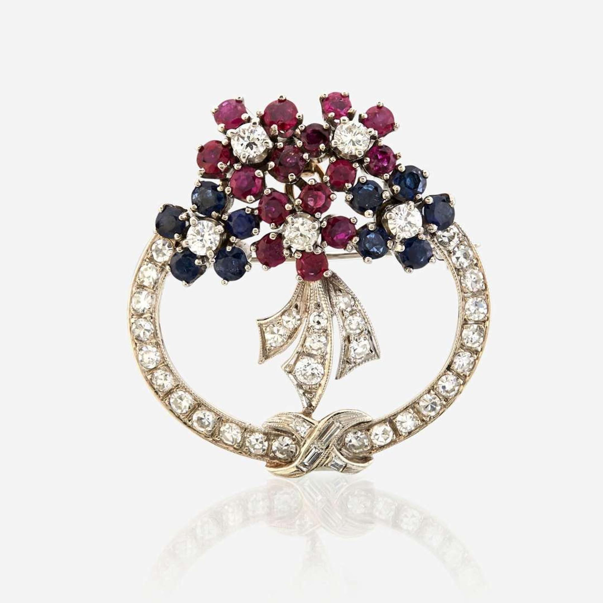 A diamond, ruby, sapphire, and white gold pendant/brooch