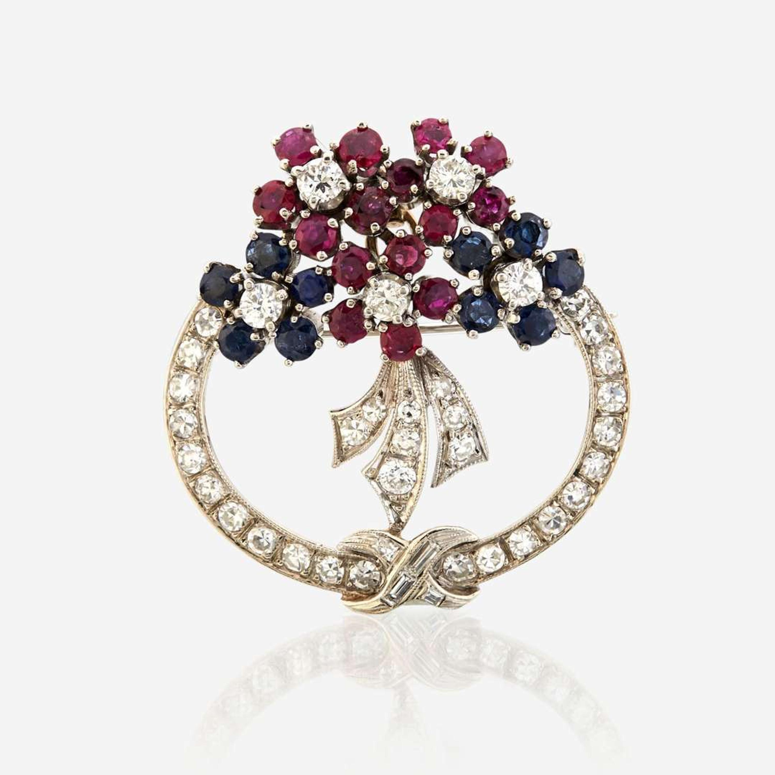 A diamond, ruby, sapphire, and white gold pendant/brooch