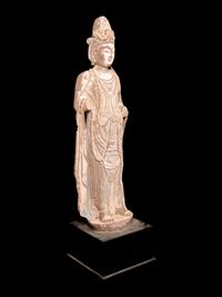 A Chinese Carved Sandstone Buddha with Remnants of Polychrome Decoration