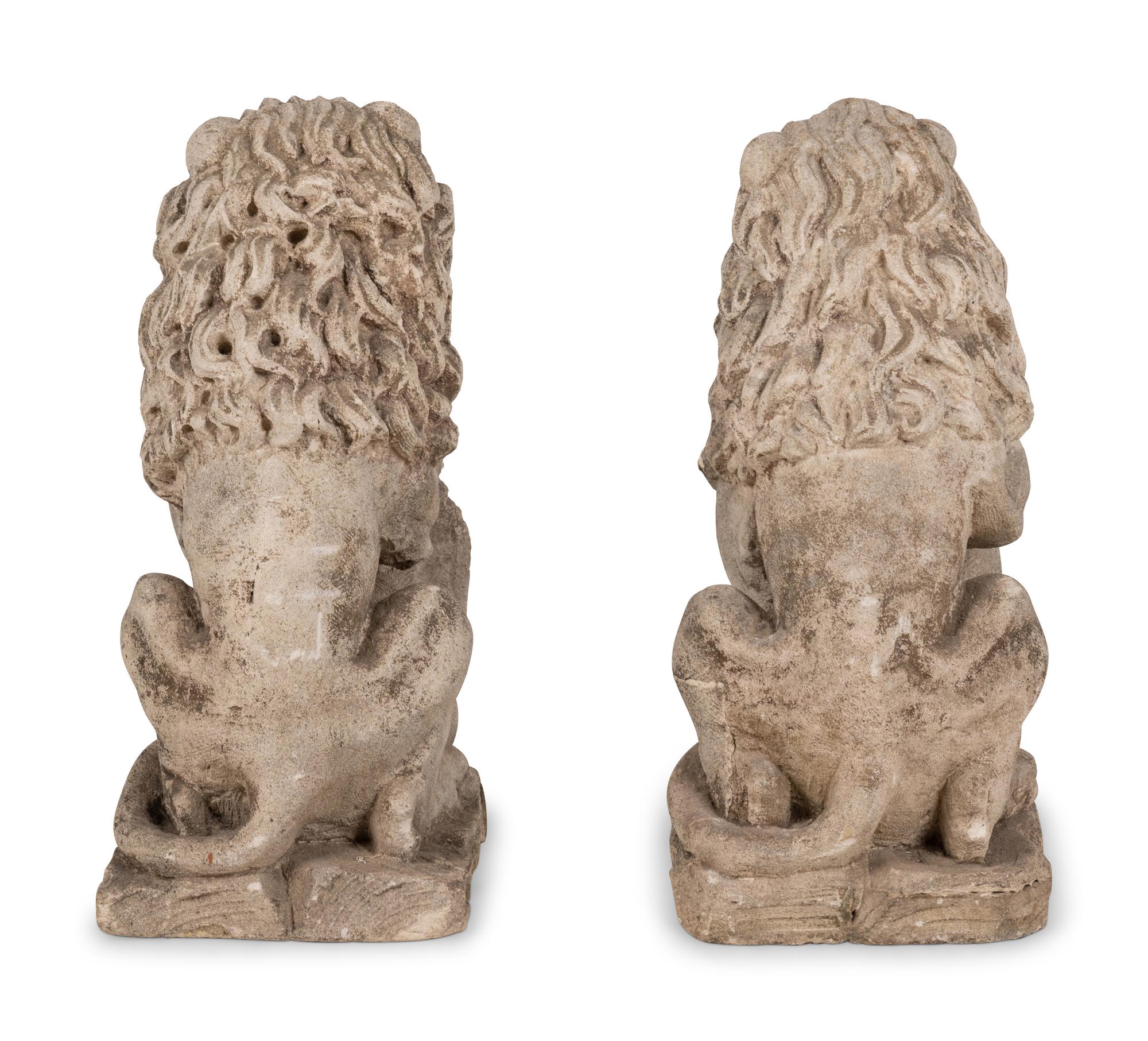 A Pair of Cast Stone Lion Figures