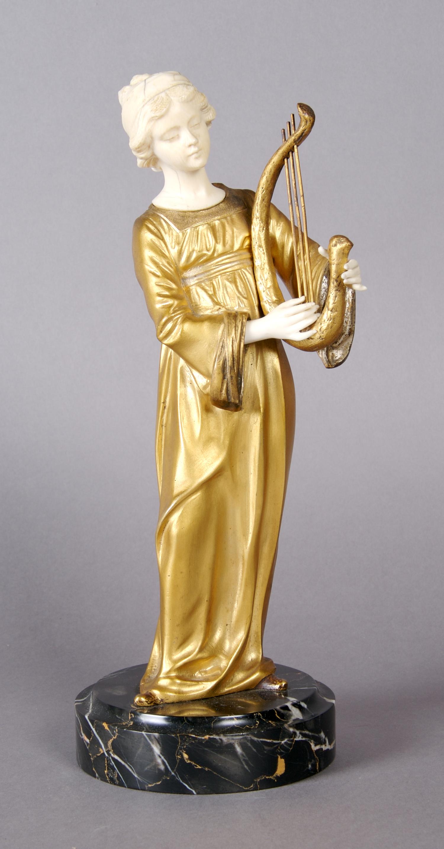 A French Ivory and Bronze Figure, Gori, Height overall 11 1/2 inches.
