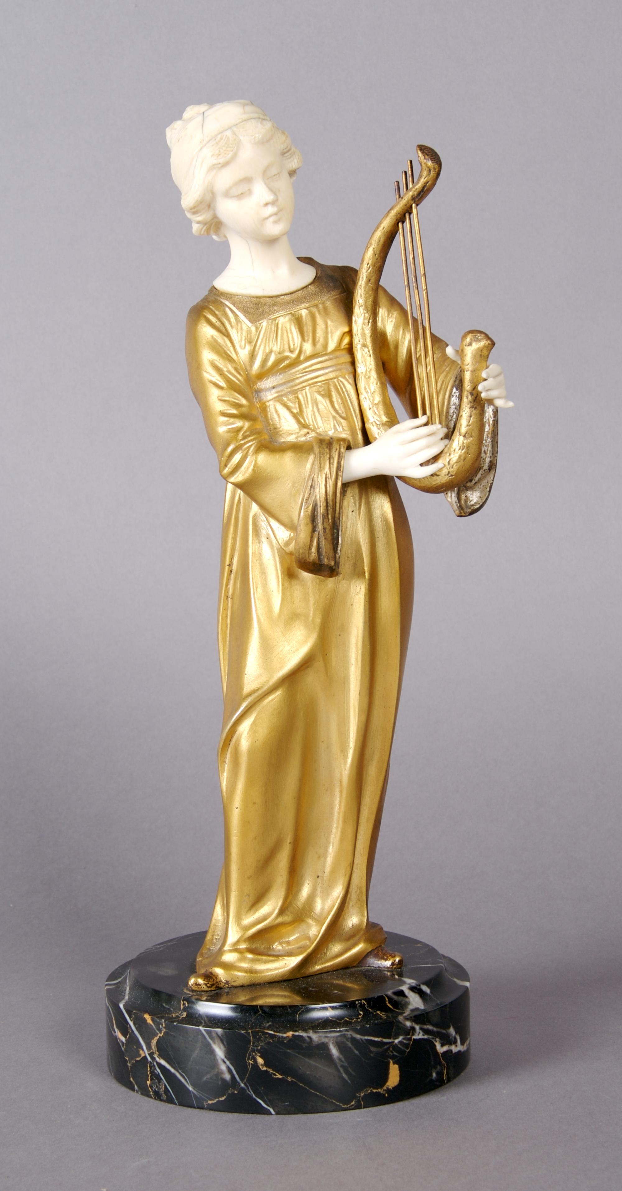 A French Ivory and Bronze Figure, Gori, Height overall 11 1/2 inches.