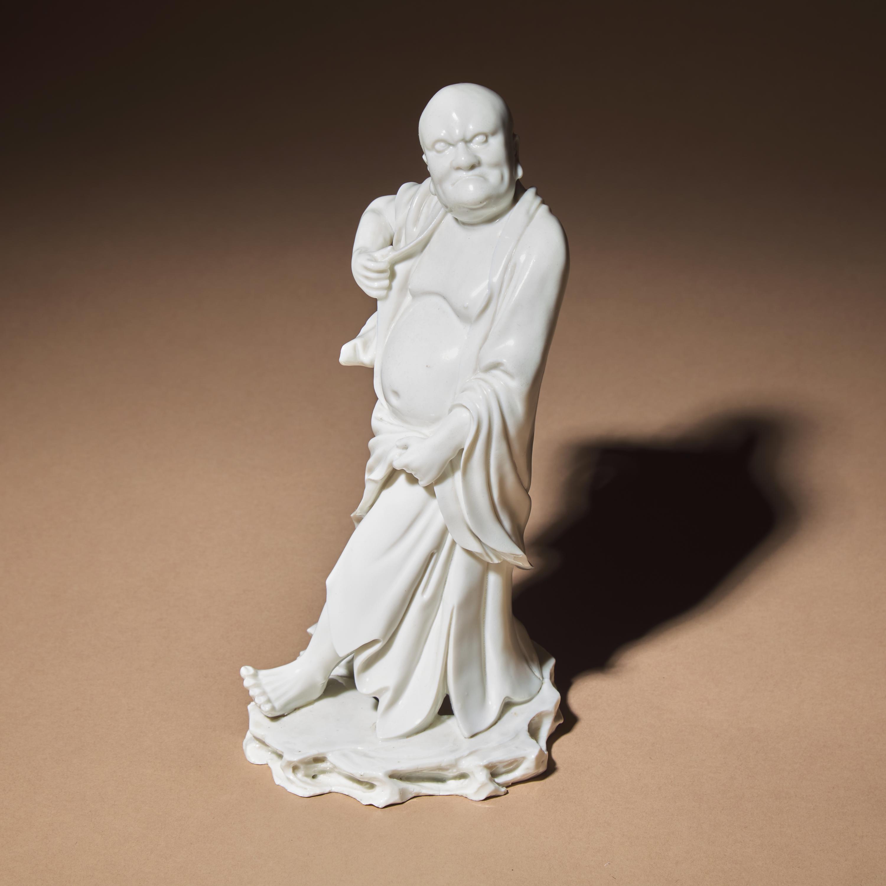 A Chinese Blanc-de-Chine Porcelain Standing Figure of a Luohan, Qing Dynasty — 清 德化白瓷羅漢立像