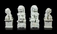 Two Pairs of Chinese Blanc-de-Chine Porcelain Figures of Fu Lions