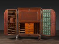 A Carved Walnut Wooton Secretary Desk