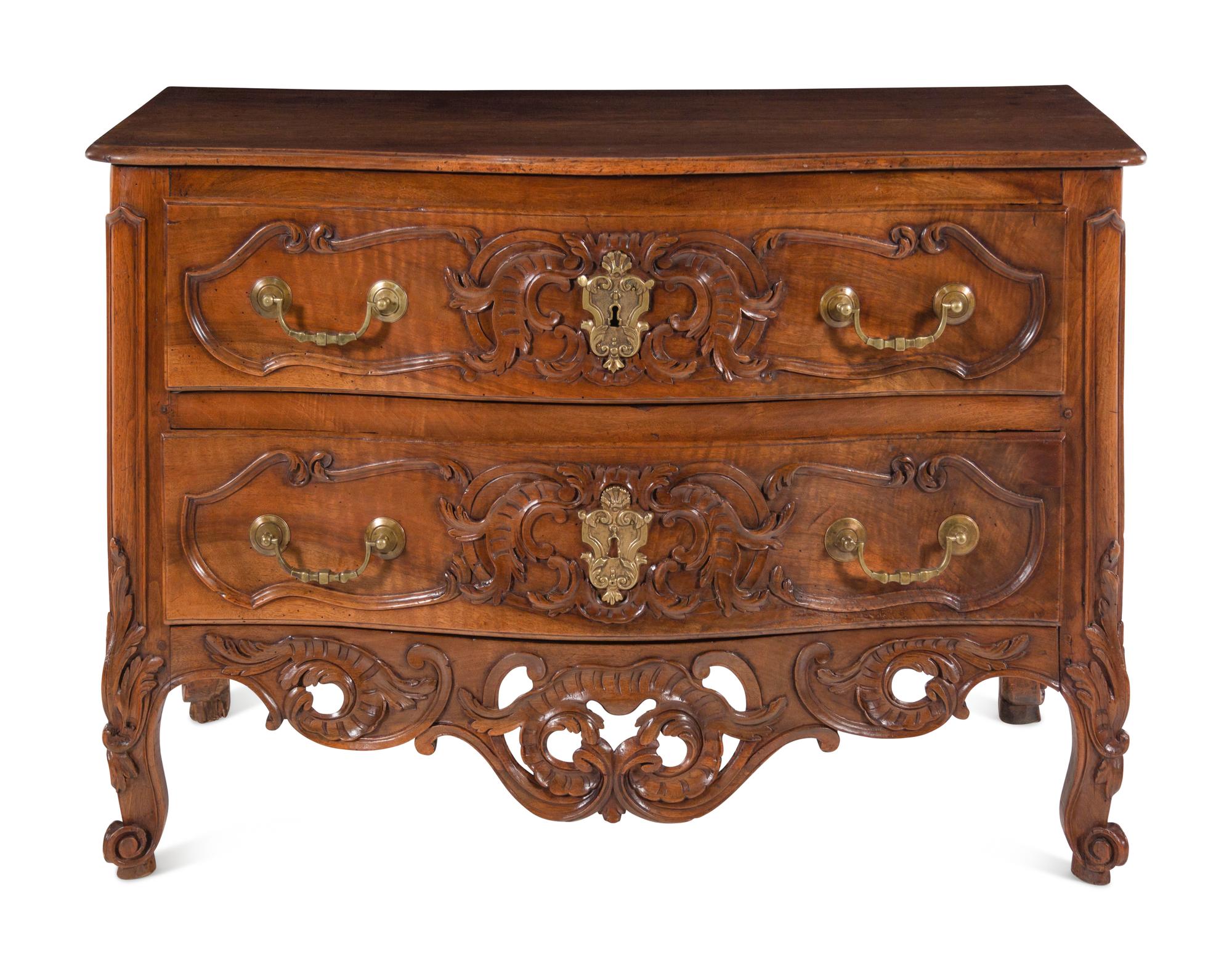 A Louis XV Provincial Carved Walnut Commode