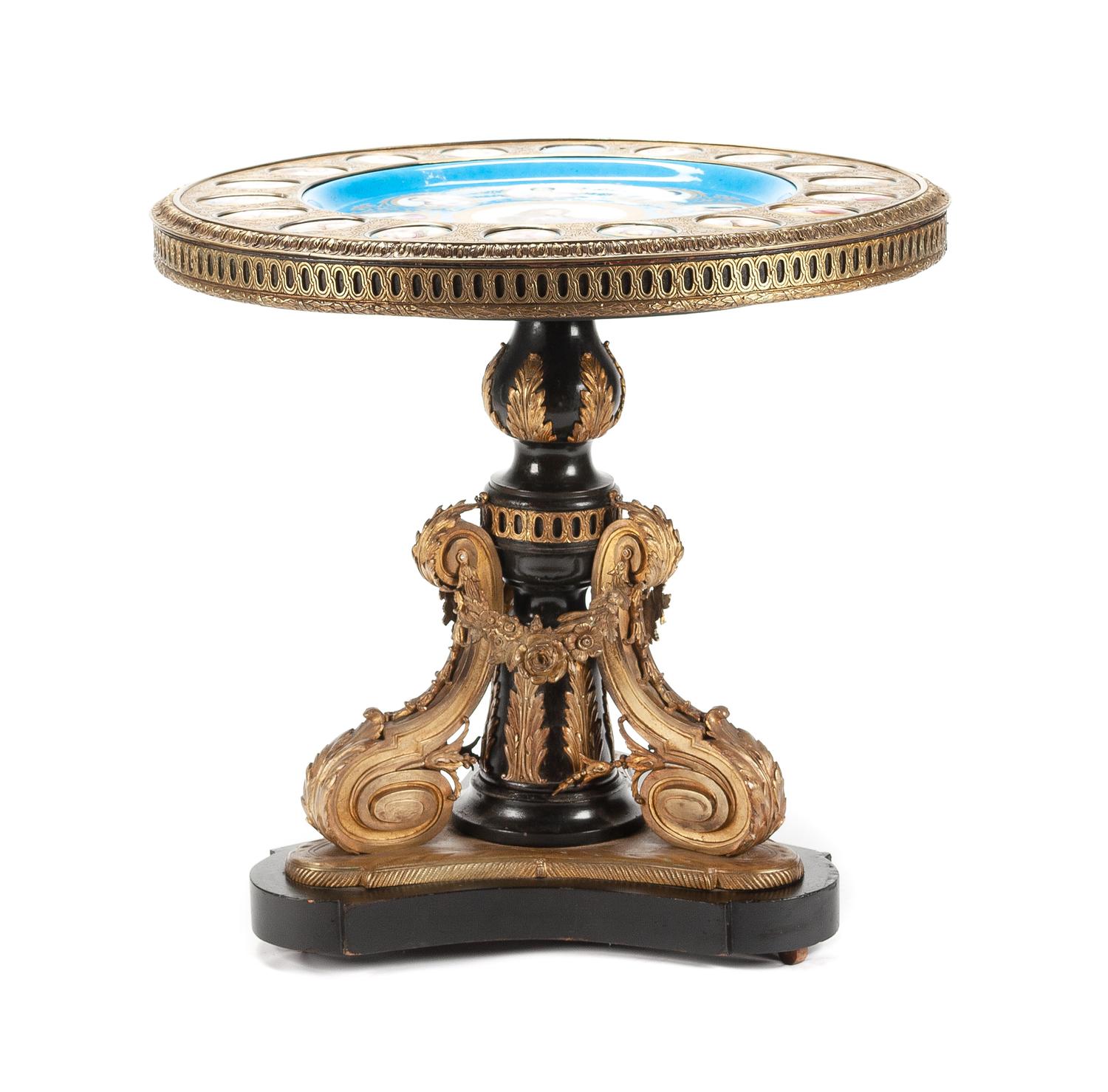 A Napoleon III Porcelain Mounted Gilt Bronze Gueridon Height 30 1/2 x diameter of top 31 3/4 inches. — LATE 19TH CENTURY