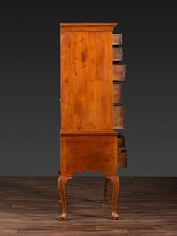 A Queen Anne Figured Walnut Flat-Top Trifid-Foot High Chest