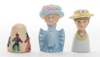 A Group of Two Porcelain Figural Thimbles Height of tallest 2 1/8 inches.