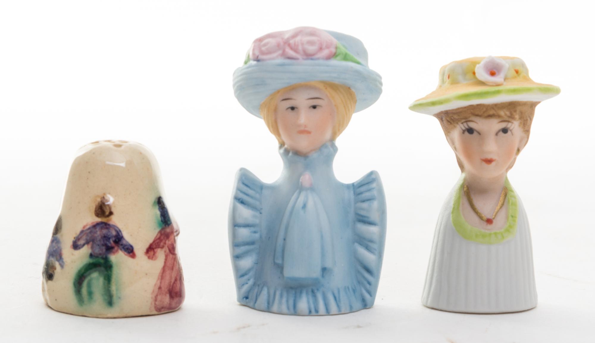 A Group of Two Porcelain Figural Thimbles Height of tallest 2 1/8 inches.