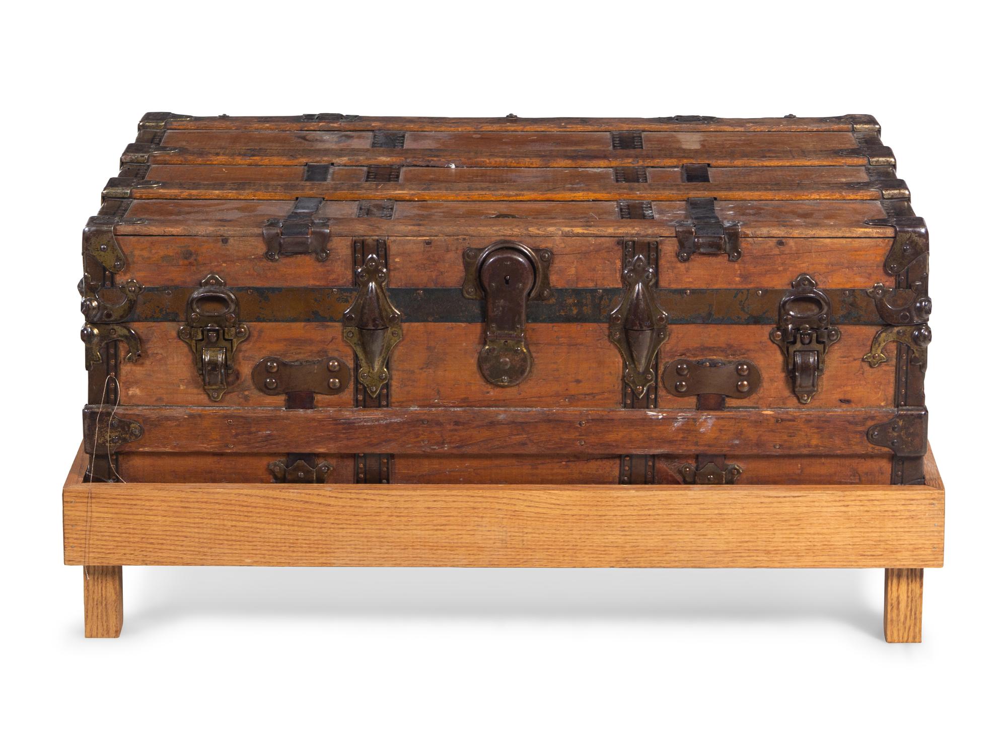 A Goldsmith & Son Never Break Trunk Raised on a Later Stand as a Table