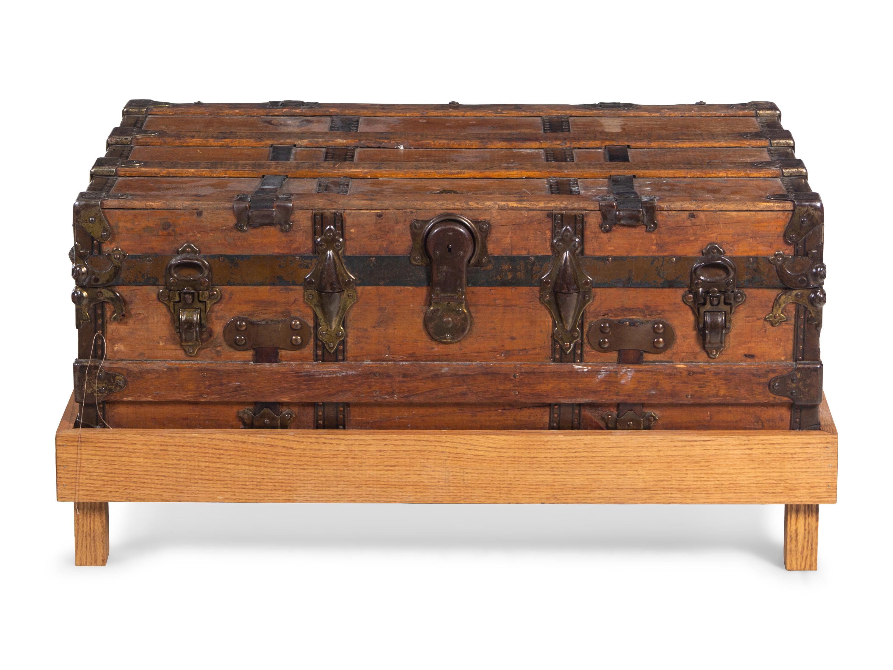 A Goldsmith & Son Never Break Trunk Raised on a Later Stand as a Table