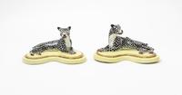 A Pair of Porcelain Models of Recumbent Cheetahs Width 7 3/4 inches. — 20TH CENTURY