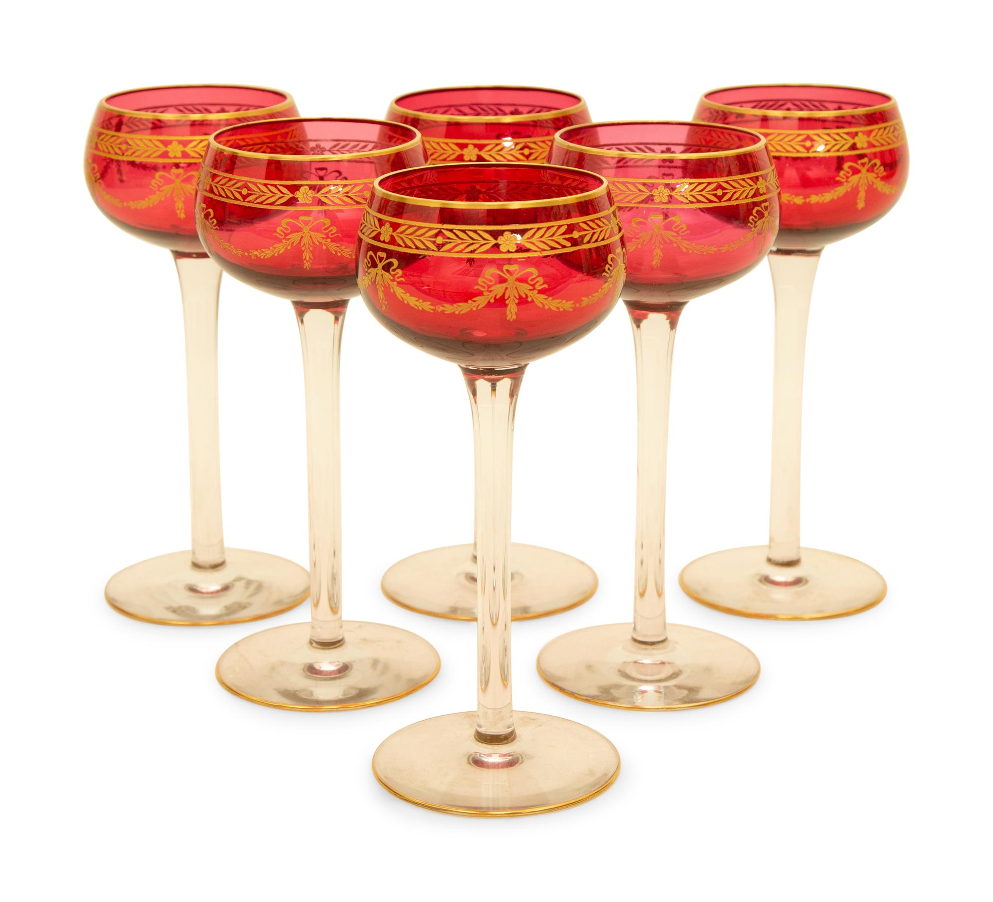 A Set of Twelve Bohemian Gilt Decorated Cranberry Glass Stemmed White Wines — 19th/20th Century