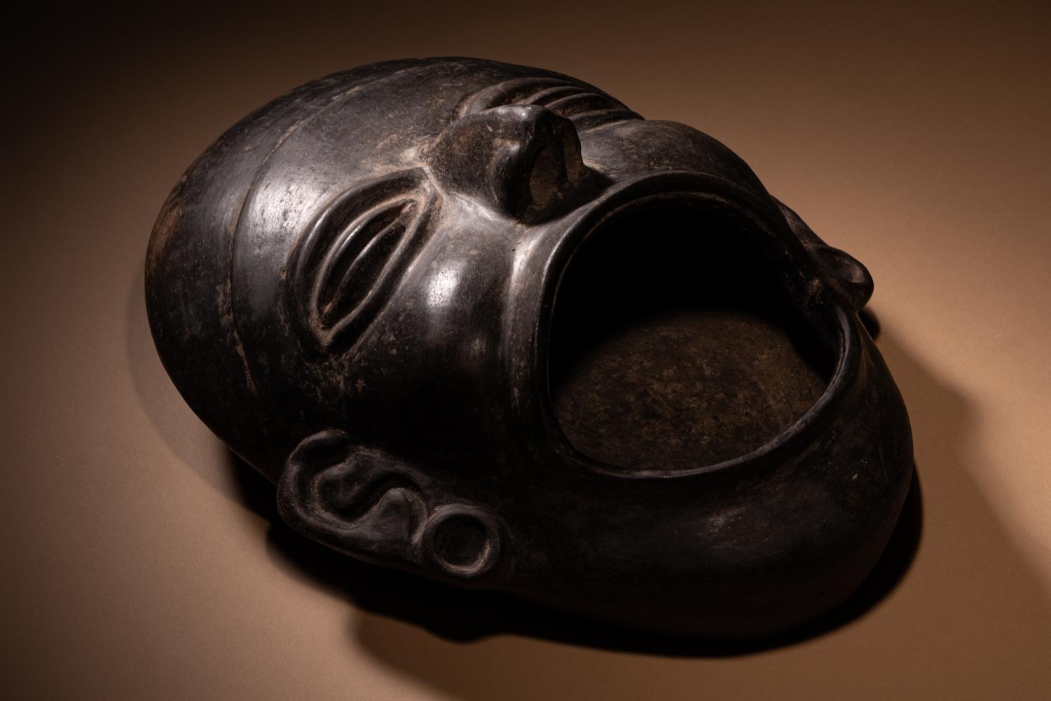 An Olmec Blackware Effigy Vessel in the Form of a Human Face