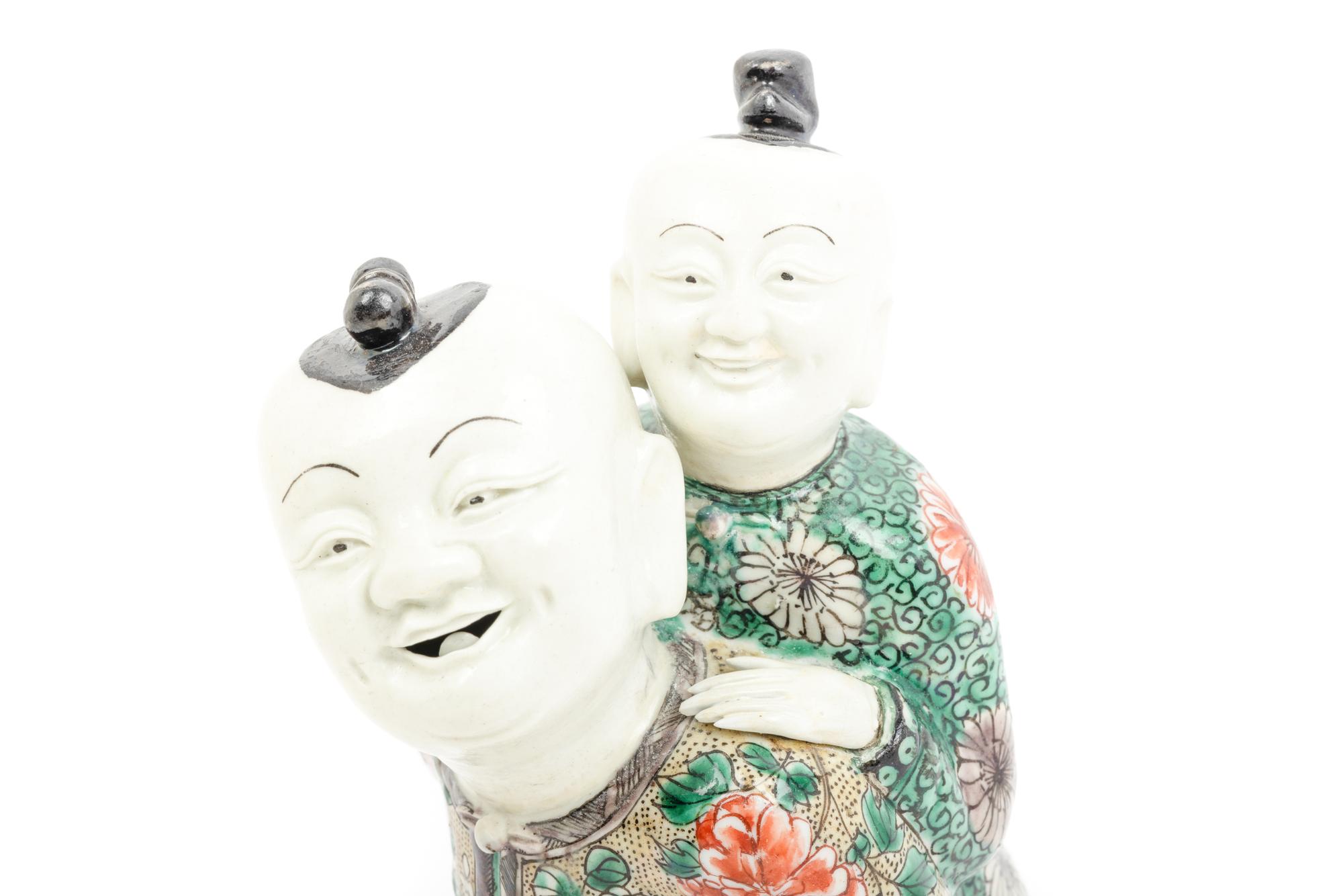A Chinese Famille Verte Biscuit Porcelain 'Piggyback' Group