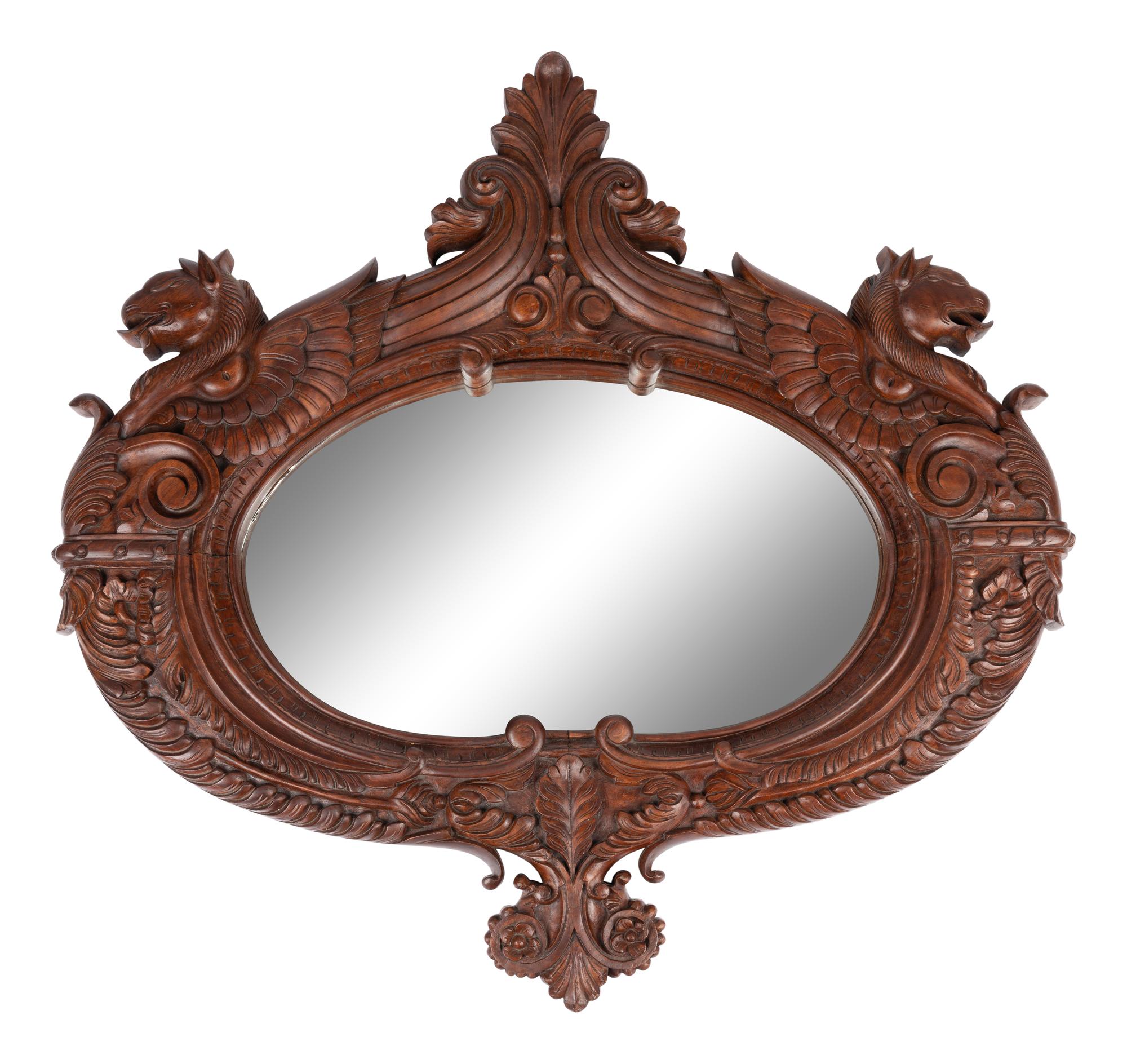 A Carved Mahogany Oval Mirror with Opposing Griffins