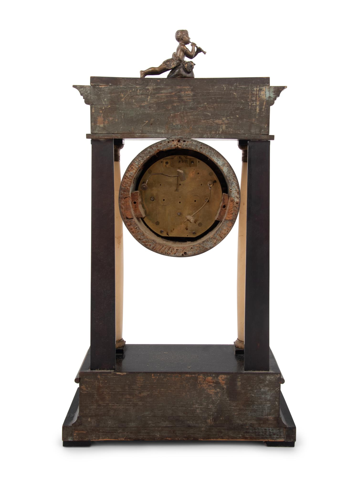 An Empire Style Gilt Metal and Alabaster Mounted Ebonized Clock
