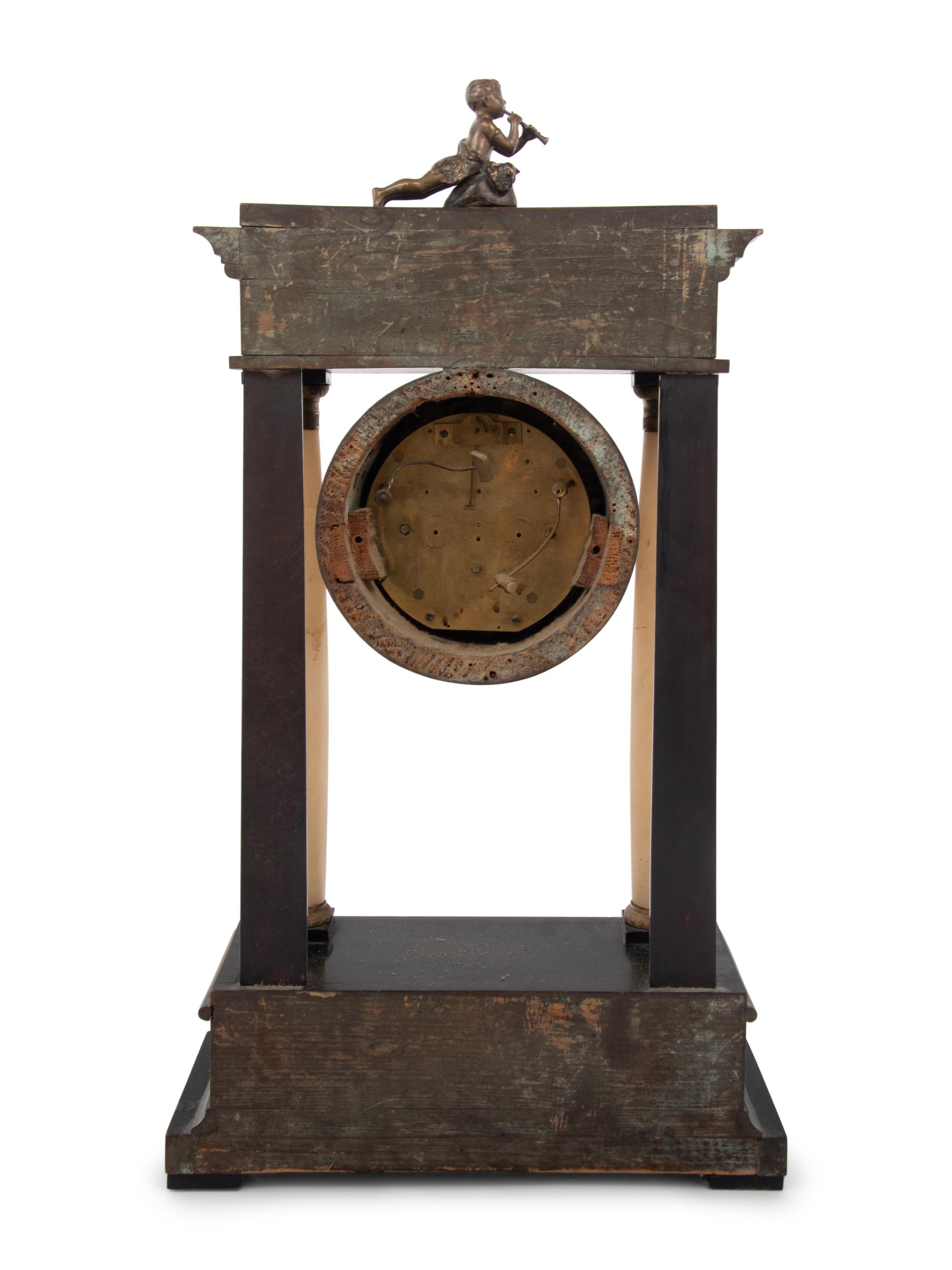 An Empire Style Gilt Metal and Alabaster Mounted Ebonized Clock
