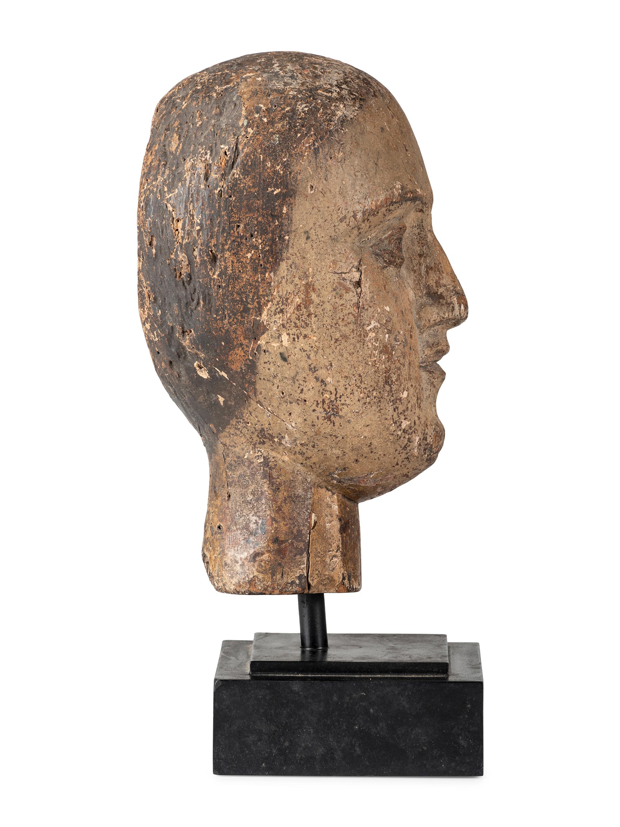 A Carved and Painted Wooden Head