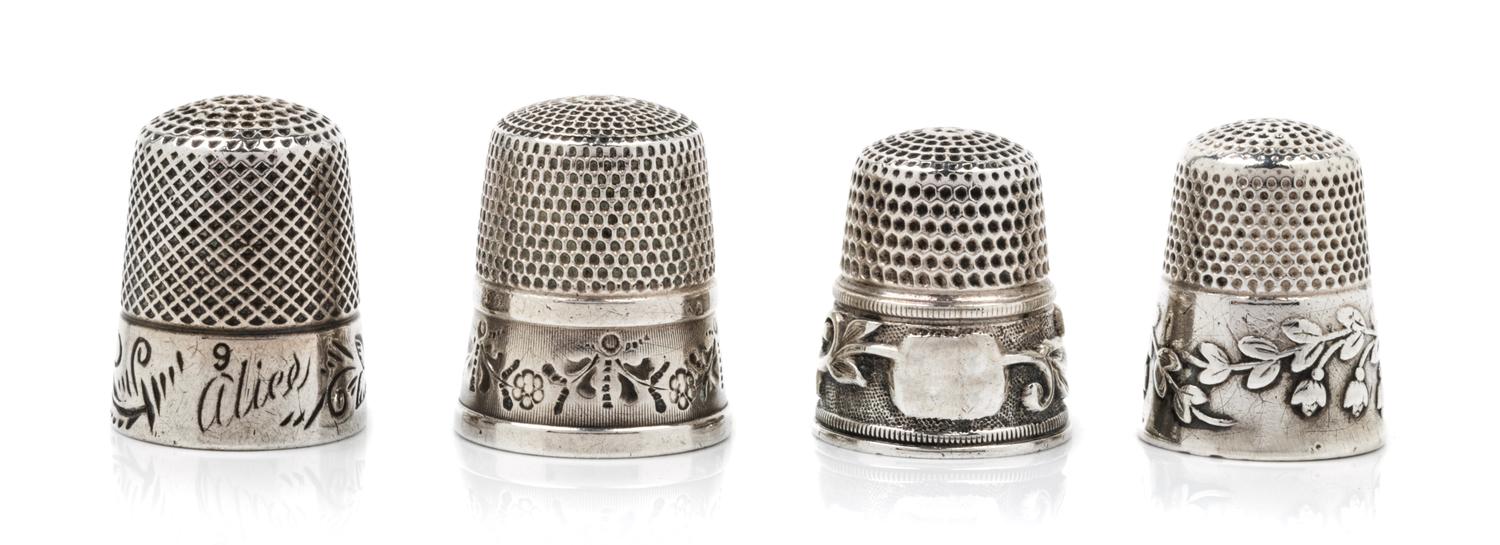 A Group of Four American Silver Thimbles, Various Makers, comprising an example having a knurled top and body above a foliate and vine