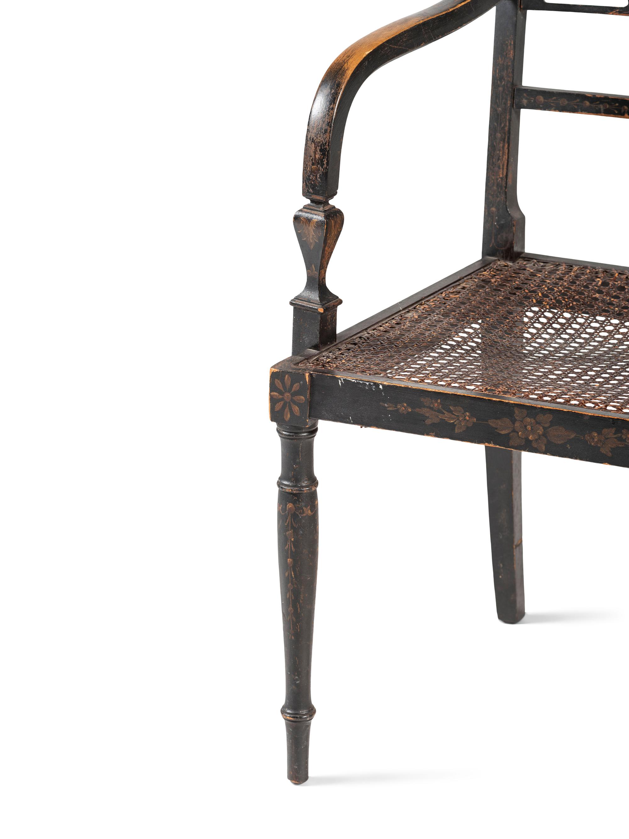 A Classical Black and Gilt Decorated Cane-Upholstered Armchair