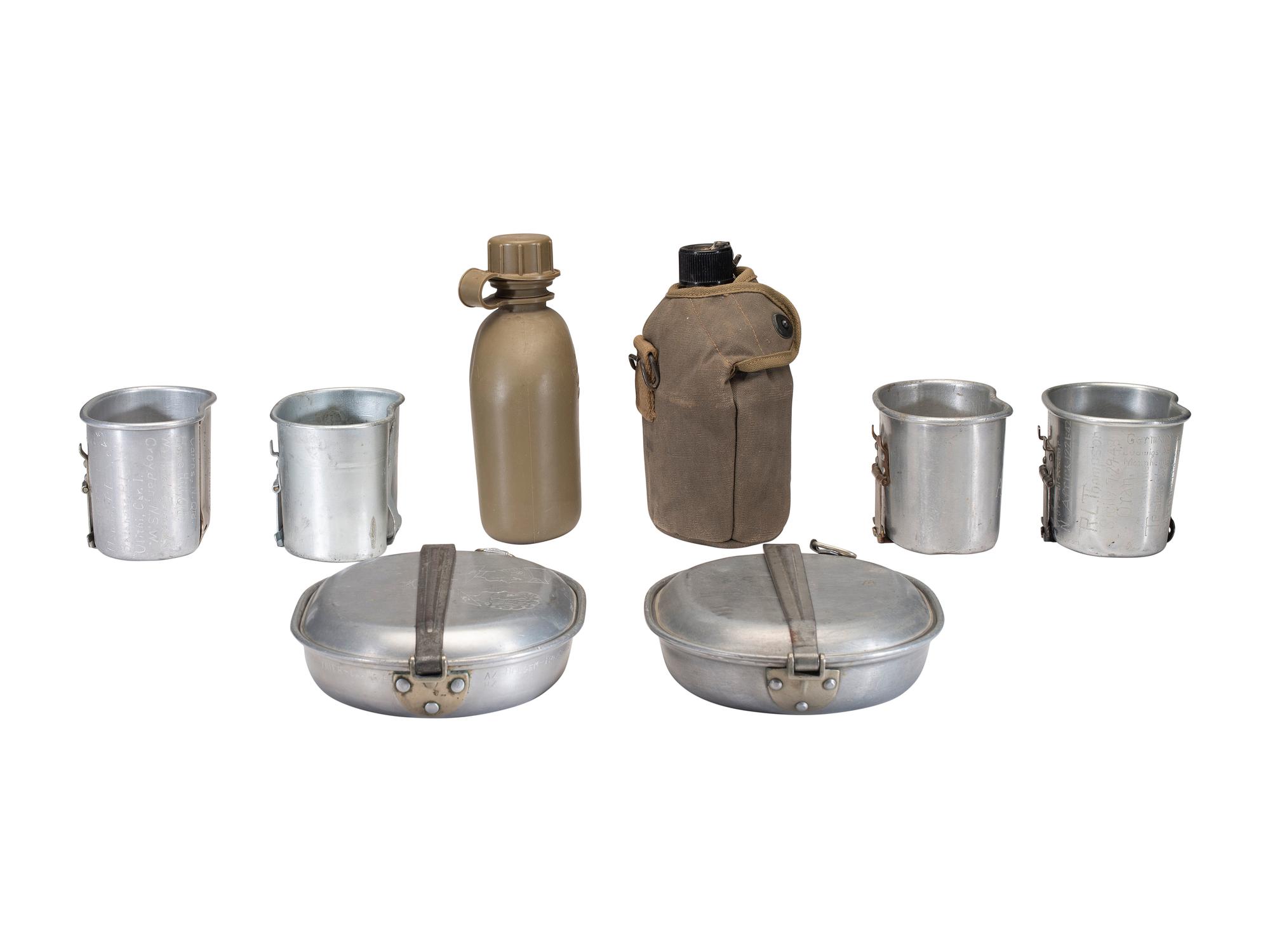 [MILITARIA]. World War II and Korean War-era canteens, canteen covers, and mess kits.