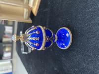 A 14 Karat Vari-Color Gold, Guilloché Enamel, Diamond, and Cabochon Jewel-Mounted Egg-Form Perfume and a Related Guilloché Enamel, 14 Karat Vari-Color Gold, Diamond, and Cabochon-Mounted Surprise Egg