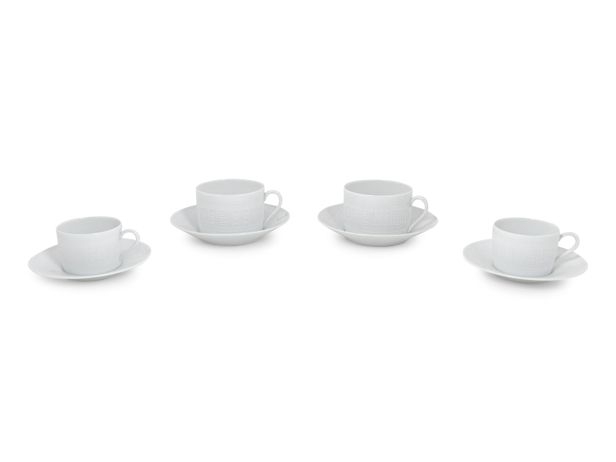 A Group of Hermès Egée Porcelain Cups and Saucers
