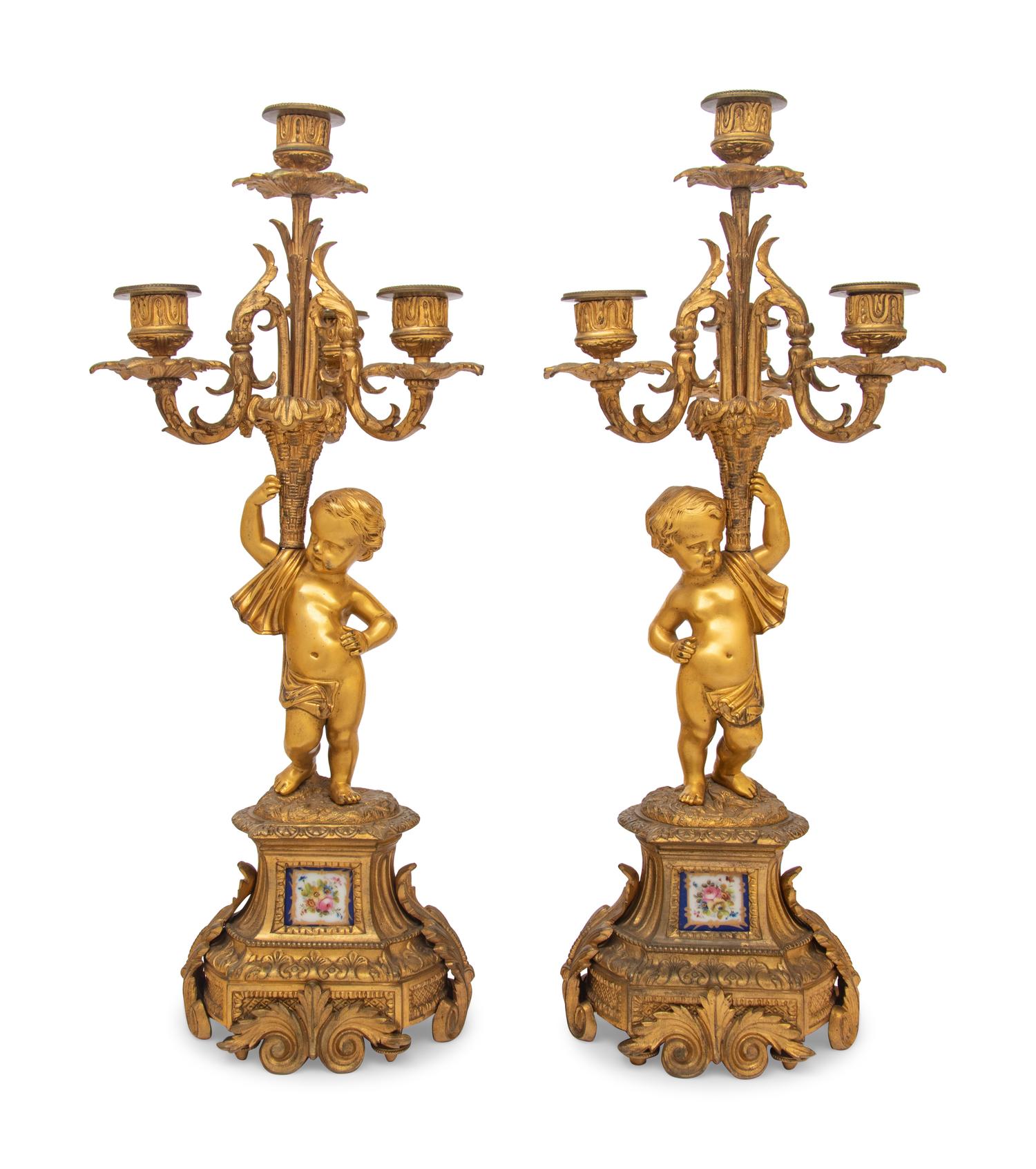 A Pair of French Gilt Bronze and Porcelain Inset Four-Light Candelabra