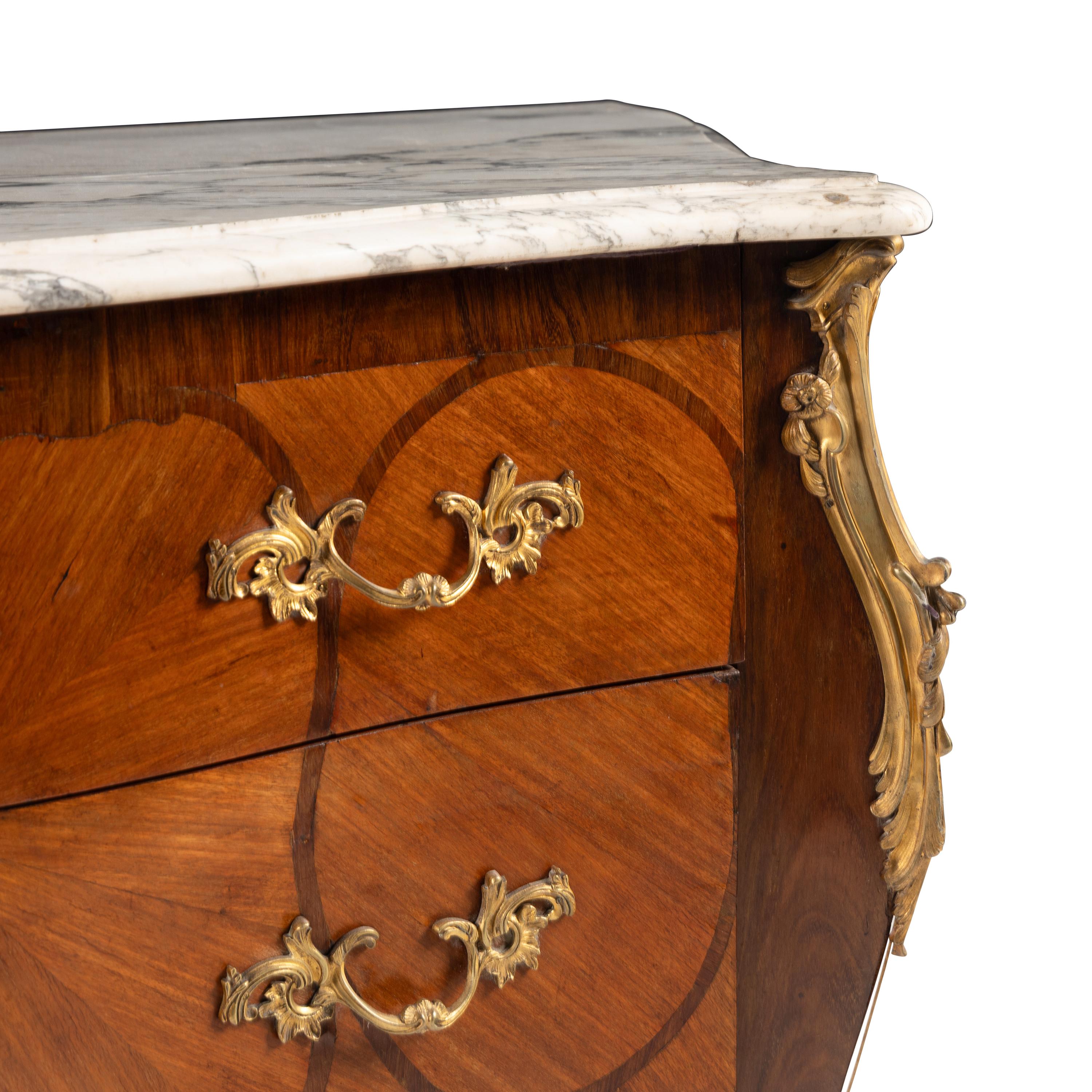 A Louis XV Style Gilt Bronze Mounted Mahogany and Parquetry Marble-Top Bombé Commode