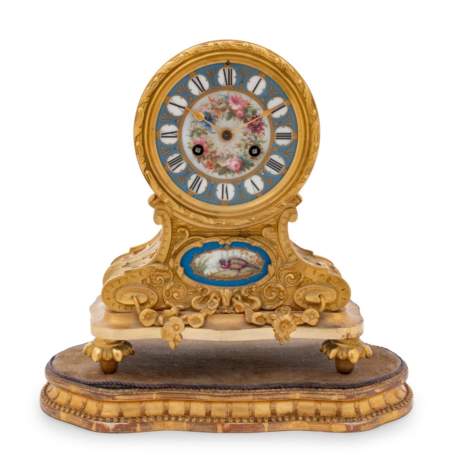 A Louis XVI Style Gilt Bronze and Sèvres Style Porcelain Inset Mantel Clock