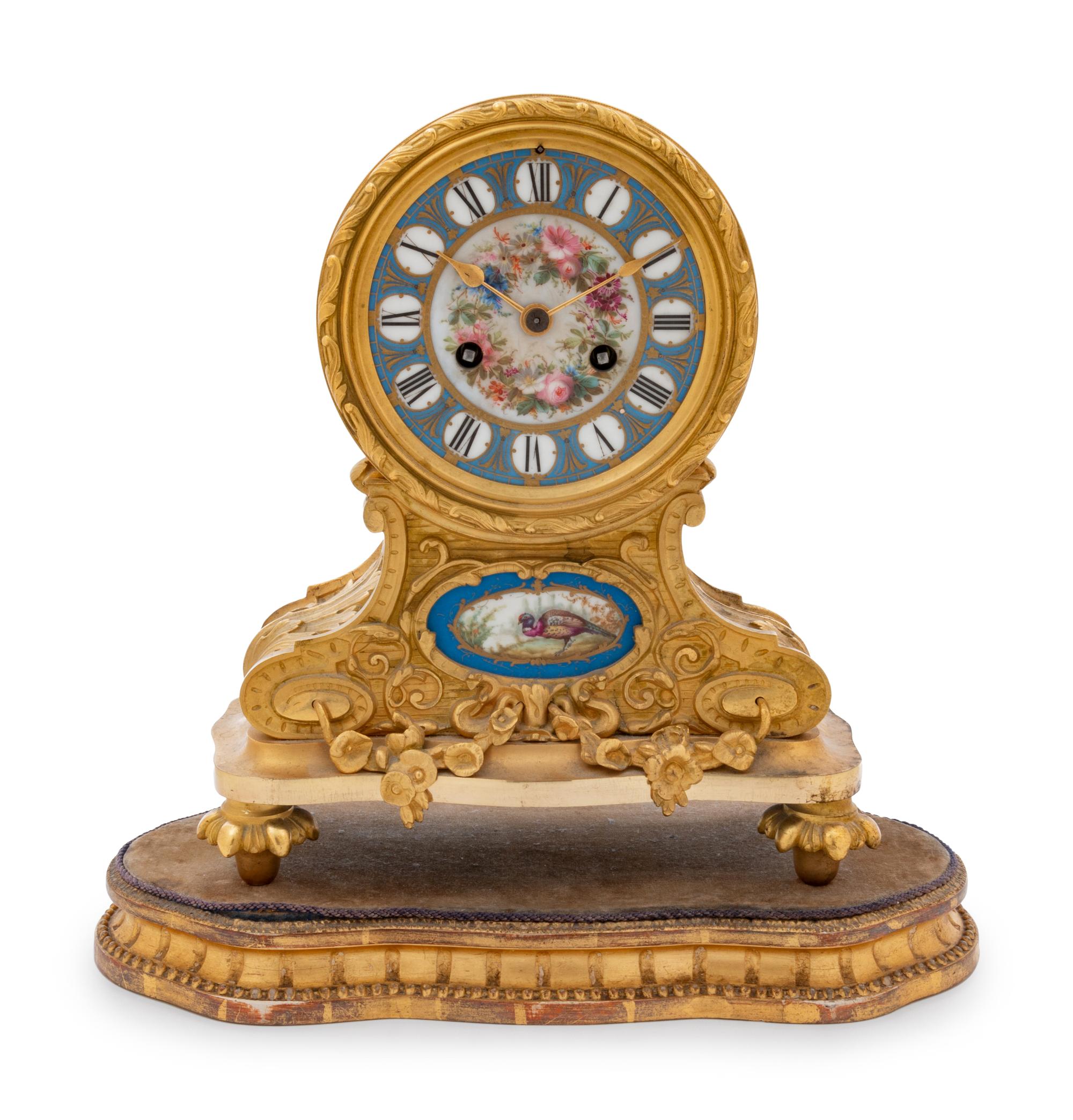 A Louis XVI Style Gilt Bronze and Sèvres Style Porcelain Inset Mantel Clock