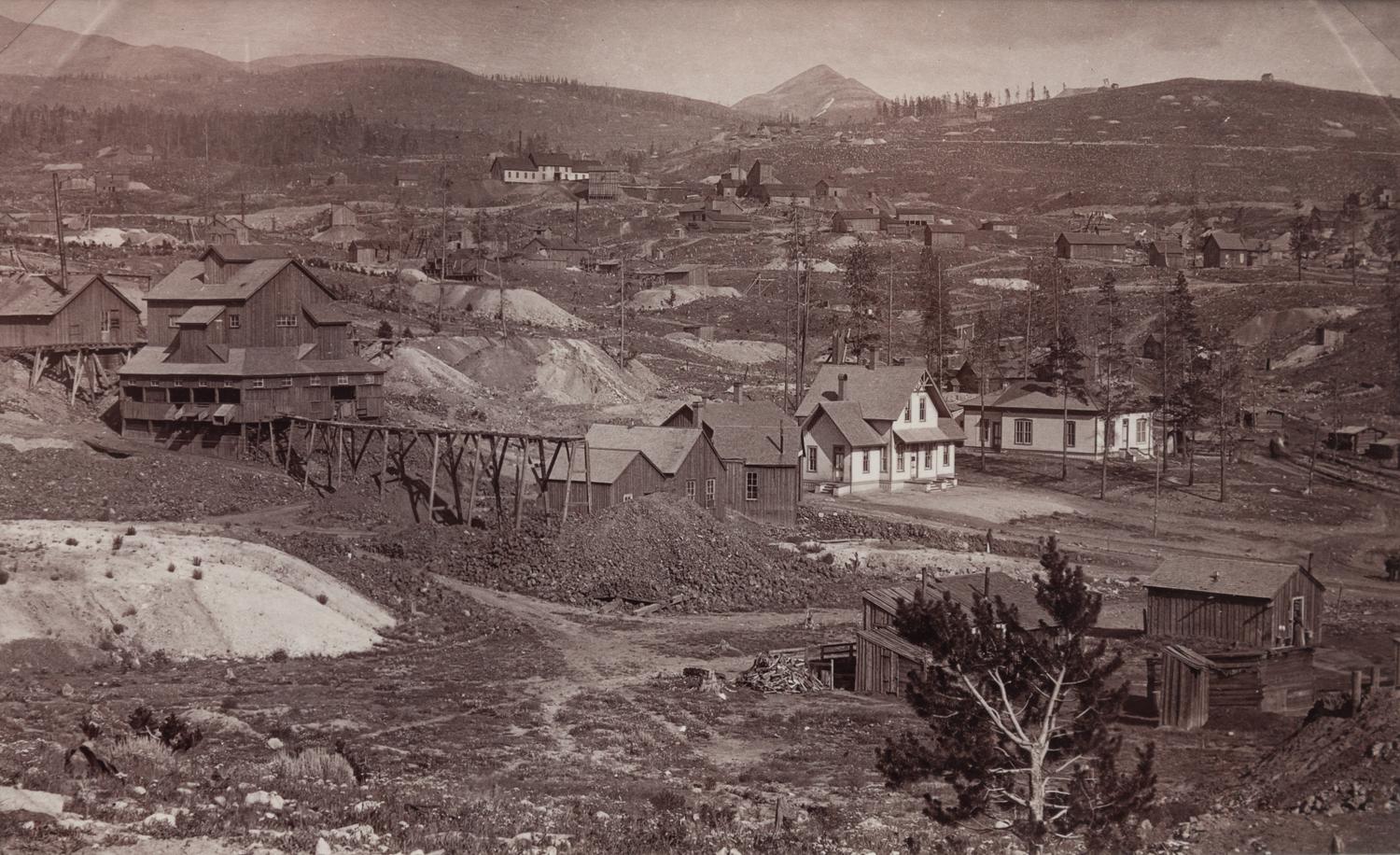 A group of four photographs (8098. Panorama of Denver; Untitled (roof tops of a town; Untitled (mining town); Georgetown)
