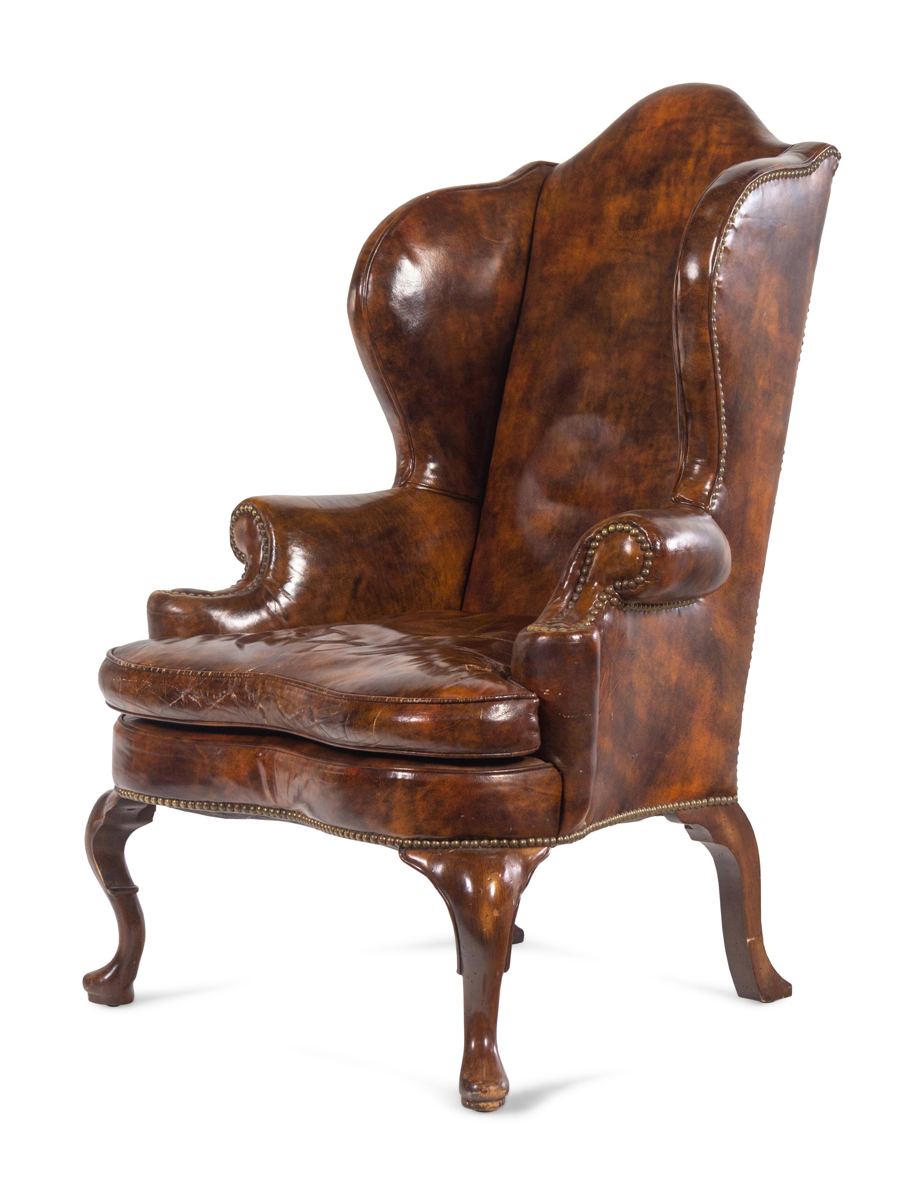 A Queen Anne Style Faux Leather Upholstered Wingback Armchair