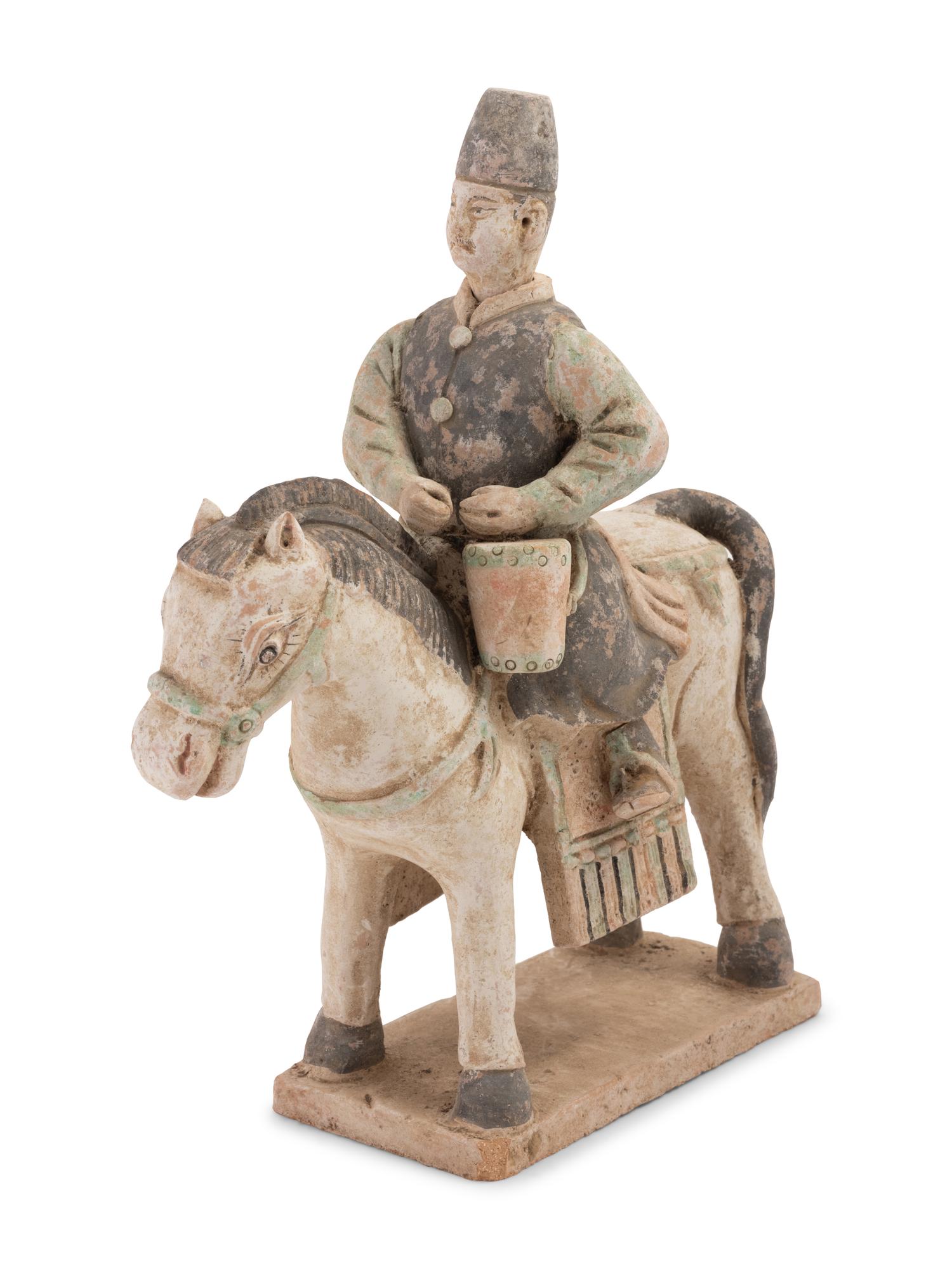 A Chinese Painted Terra Cotta Burial Figure of a Mounted Attendant