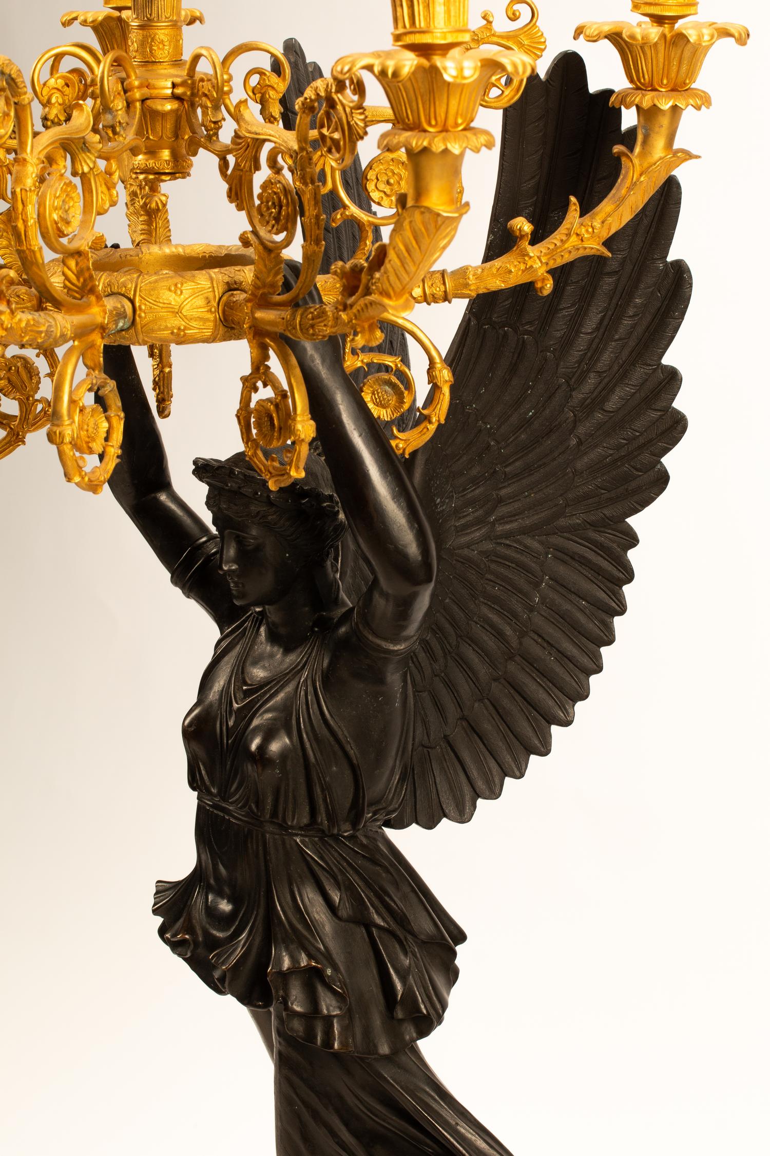 A Pair of Monumental Empire Style Gilt and Patinated Metal Seven-Light Figural Candelabra